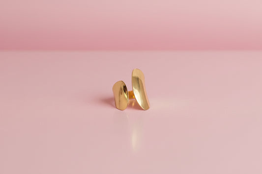 Gold ring on a pink background